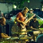 Man Holding Brown Electric Guitar