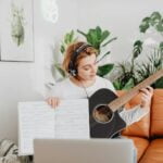 Happy Woman Playing Guitar Having Online Class