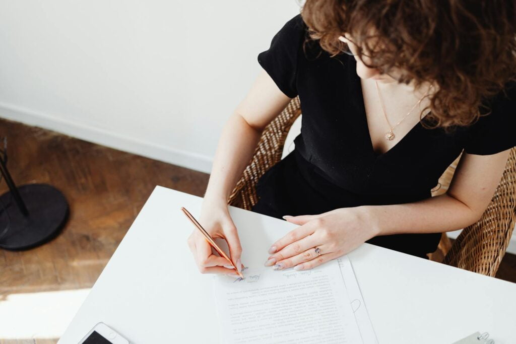 A Woman Signing a Document