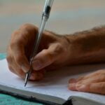 Man Writing in a Book