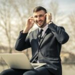 Man in Black Suit Jacket Using Macbook
