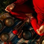 Person in Red Long Sleeve Shirt Holding Brown Wooden Handle